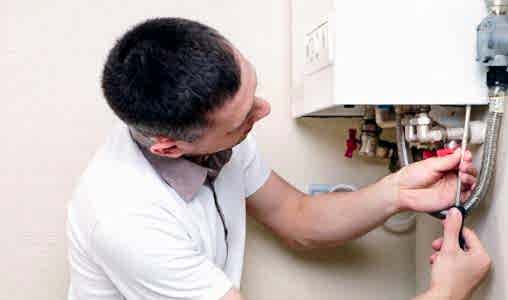 guy fixing a heater system 