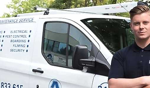 an able group engineer standing in front of a able group service van